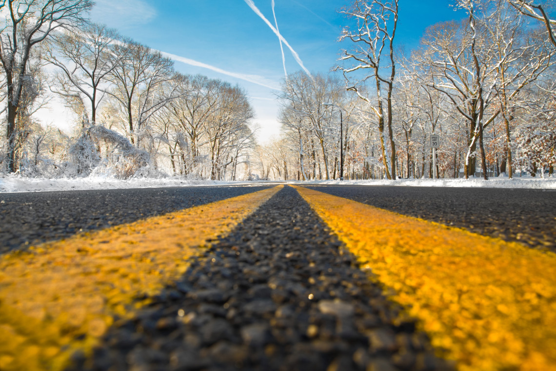 Yellow dividing line on road on winter day